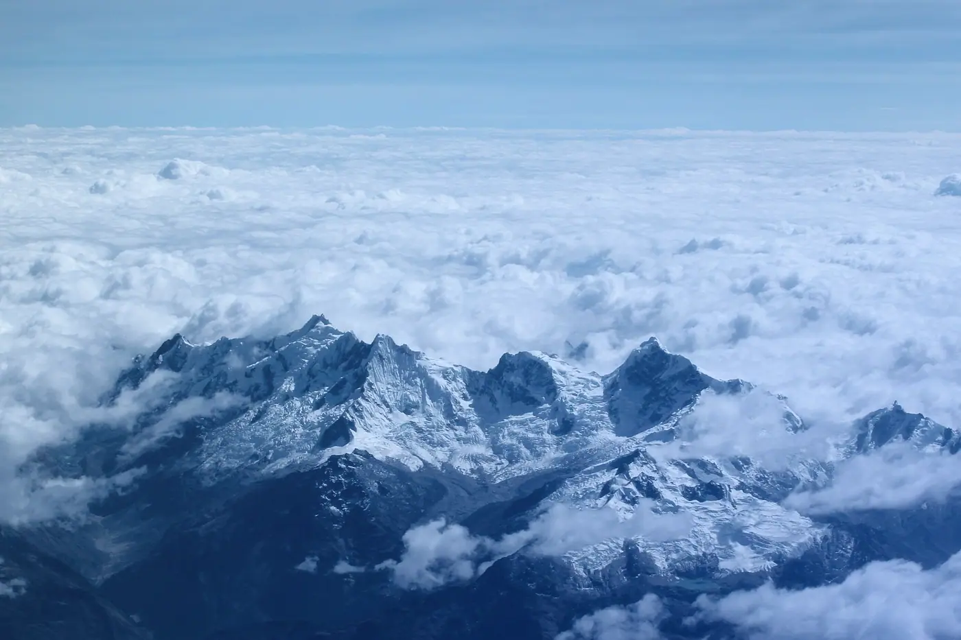 A sea of clouds around mountain peaks